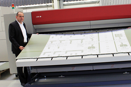 Markus Permesang next to the 48-up platesetter from Agfa Graphics