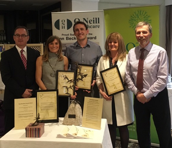 Claire Gleeson, Kieran Lewis and Dr Clodagh Nolan, Trinity occupational therapists with Career Pathways at the presentation of the Ann Beckett Award at the AOTI National Seminar Day are congratulated by John O'Neil, O'Neill Healthcare, award sponsors (left) and Andrew Semple, Head of the AOTI Ann Beckett Committee (far right)