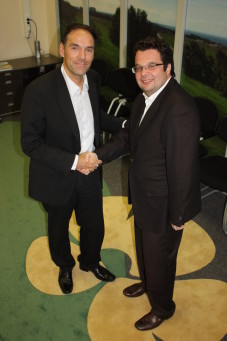 Arla's Senior Vice President Hans Christensen confirms the acquisition of Artis by shaking hands with Artis director Mike Lyasko.