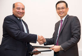 EBRD President Sir Suma Chakrabarti shakes hands  with IE Singapore CEO Teo Eng Cheong